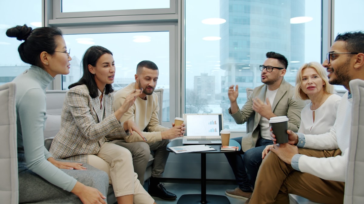 A diverse team of colleagues discussing ideas together in a bright modern office.