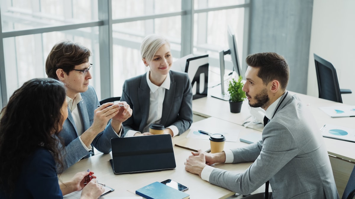 Professionals in an inclusive workplace meeting reviewing work together.